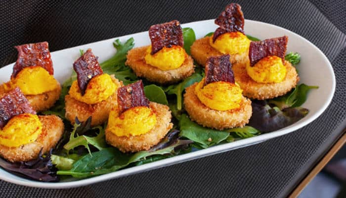 Deliveredegg - Startup Stride - Startup Stride Delicious dish with crispy items topped with yellow filling, perfect for a carnivore diet plan, highlighting high-protein and low-carb ingredients