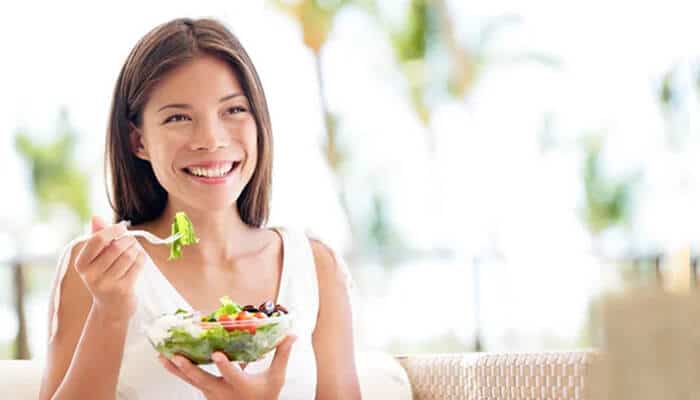 How does Grace Charis promote healthy living 1 - Startup Stride Grace Charis enjoying a healthy salad, emphasizing her healthy lifestyle and choices, reflecting her holistic approach to living, contributing to her net worth.