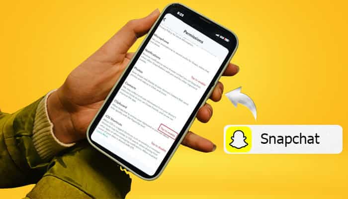How to use the clipboard on the Snapchat app - Startup Stride - Startup Stride Person holding a phone showing the Snapchat app's permissions page with 'Snapchat Clipboard' visible on the screen next to the Snapchat logo