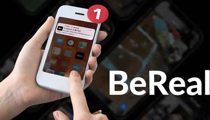 Time to BeRealWhat is the real hype - startup stride - Startup Stride Person holding a smartphone with a BeReal notification alert on the screen, highlighting user curiosity about what time does BeReal go off and how the daily prompt appears.
