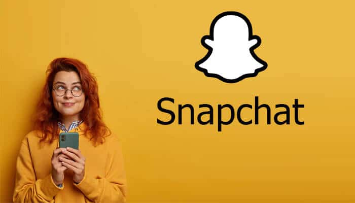 What are the best practices for using the Snapchat clipboard - Startup Stride Person holding a phone and smiling, standing in front of a yellow background with the Snapchat logo displayed next to them.