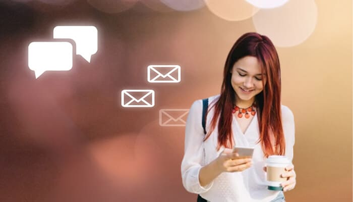What are the communication tips for Hinge users - startupstride - Startup Stride User smiling while looking at a smartphone with message bubbles, featuring the keyword'Does Hinge have read receipts' to highlight communication on Hinge.