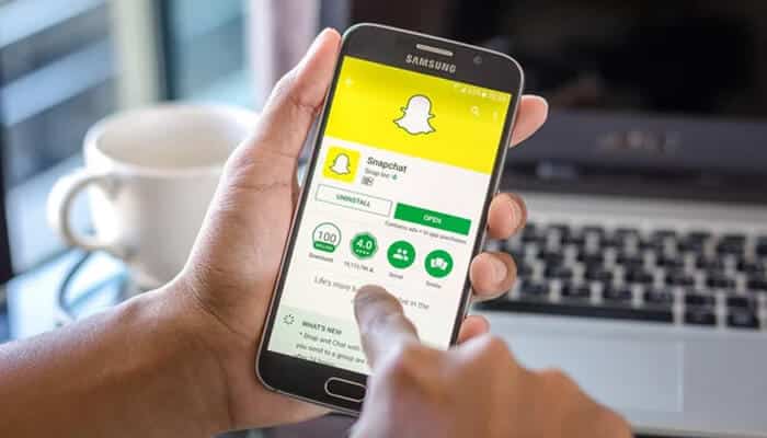 What does not increase your Snap Score - startupstride - Startup Stride A person navigating through the Snapchat app on a smartphone, explaining how Snap Score works and how it is calculated.